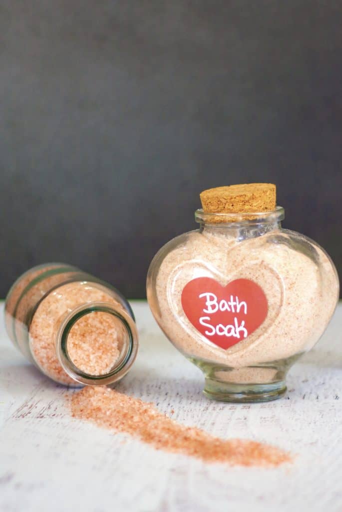 You'll fall in love with the ease of this all natural DIY pink Himalayan bath salt recipe. It's so simple, you'll never use store bought again! All you need are a few ingredients and you'll be well on your way to relaxing, relieving your stress and smelling great! All this is the perfect set up for a luxurious spa day at home! Plus, they make a great gift for those that you want to share this chemical free salt bath with as well! #DIY #homemade #beauty #pinkhimalayan #health #bathsalt