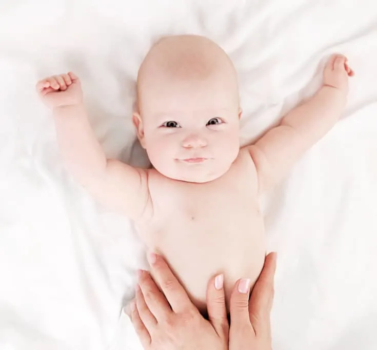 Baby getting a massage with homemade baby massage oil.