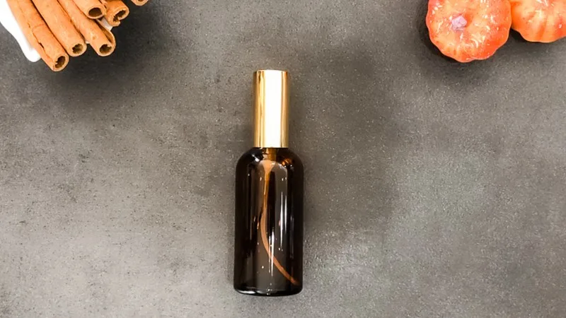Glass bottle of diy pumpkin spice essential oil room spray