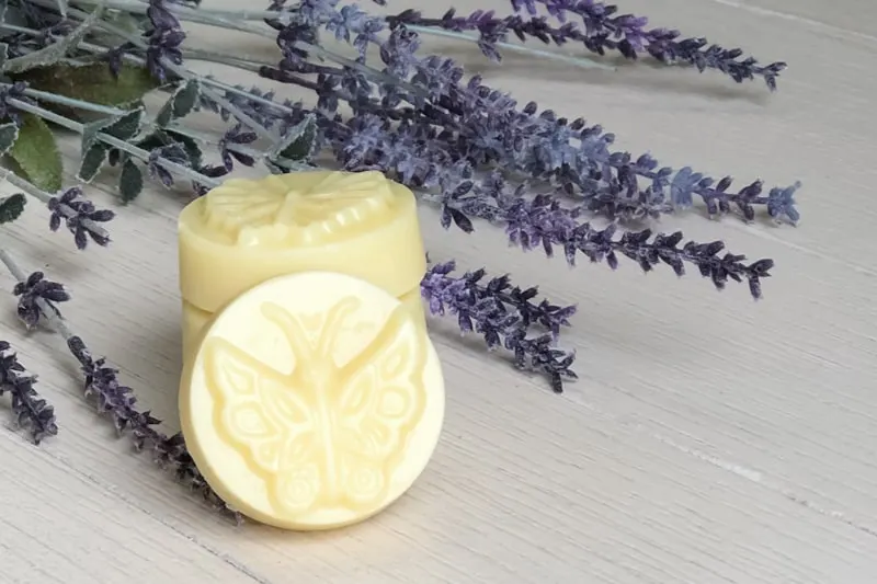 homemade natural lotion bar on a table with lavender 