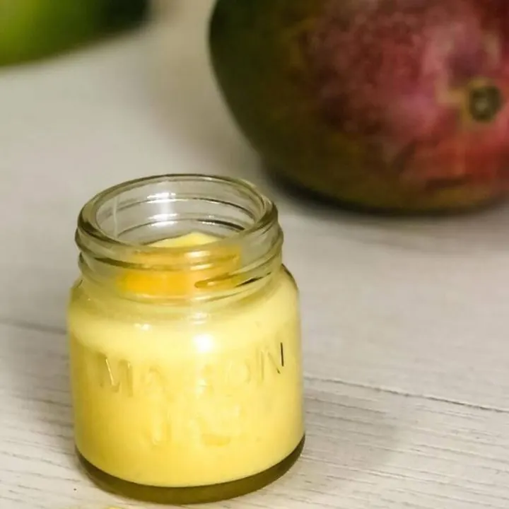 mango and jar of whipped mango body butter with spoon