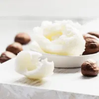 shea nuts and shea butter on a table