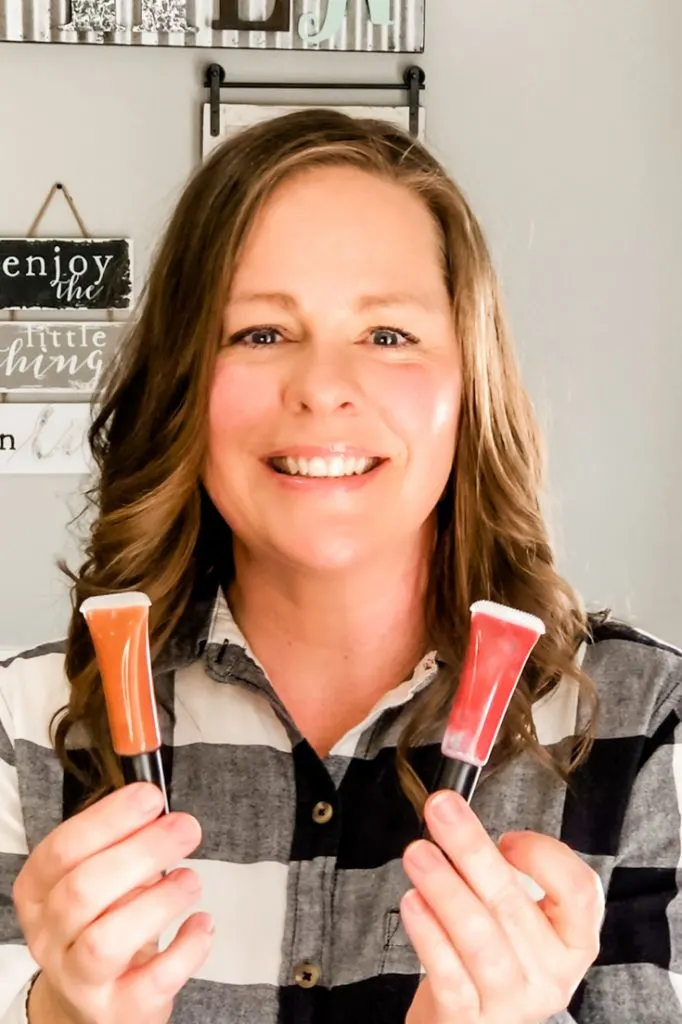 Mindy Benkert holding 2 tubes of homemade lip gloss