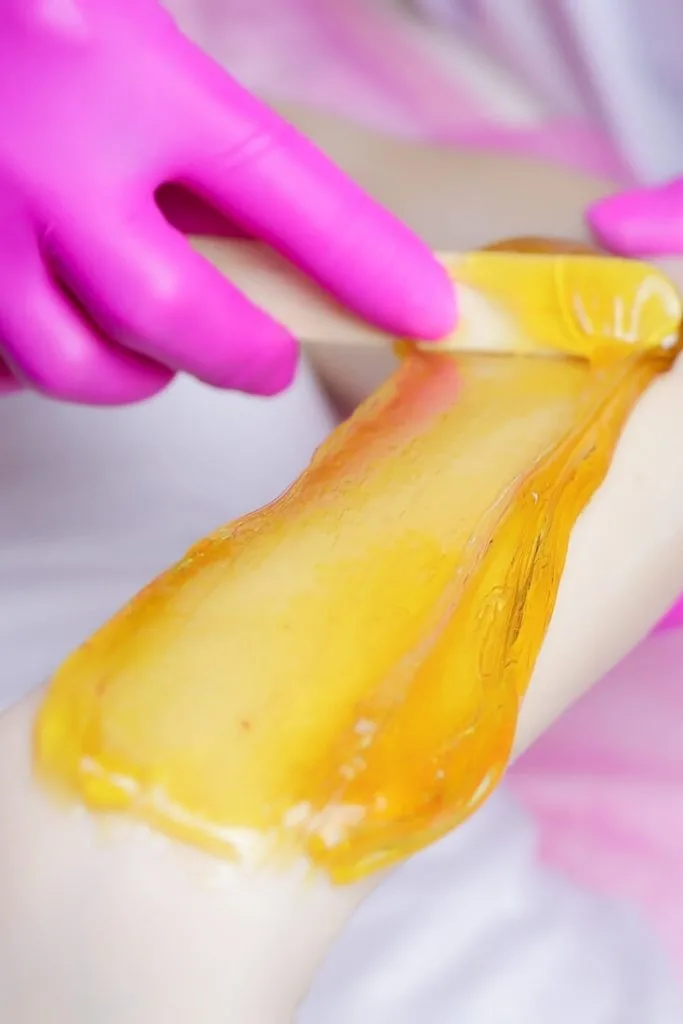 applying sugaring wax with applicator