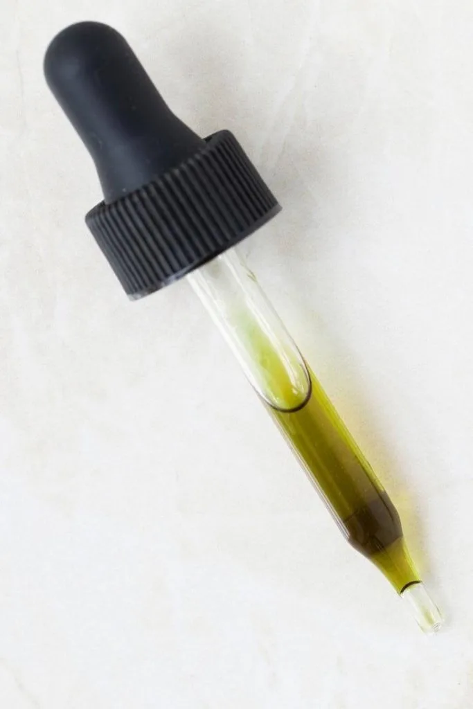 glass dropper of tamanu oil