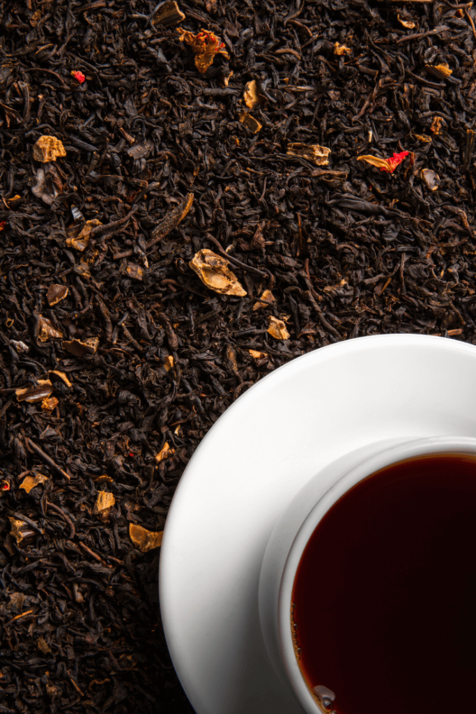 Cup of Black Tea on Tea Leaves
