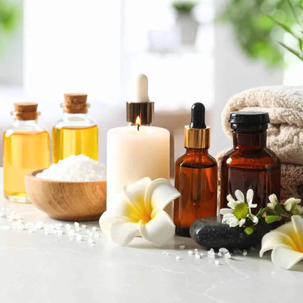 Flat lay of natural skincare ingredients including butters, oils, and seeds in small bowls